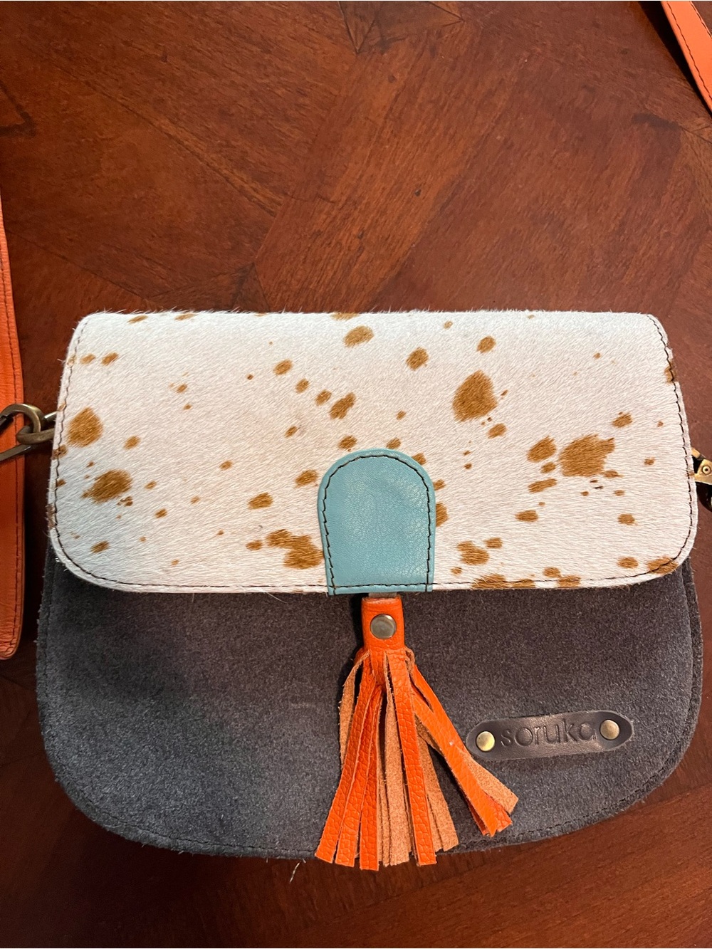 Spotted Cowhide Flap Crossbody Bag with Orange Strap and Tassel - Picture 2 of 4